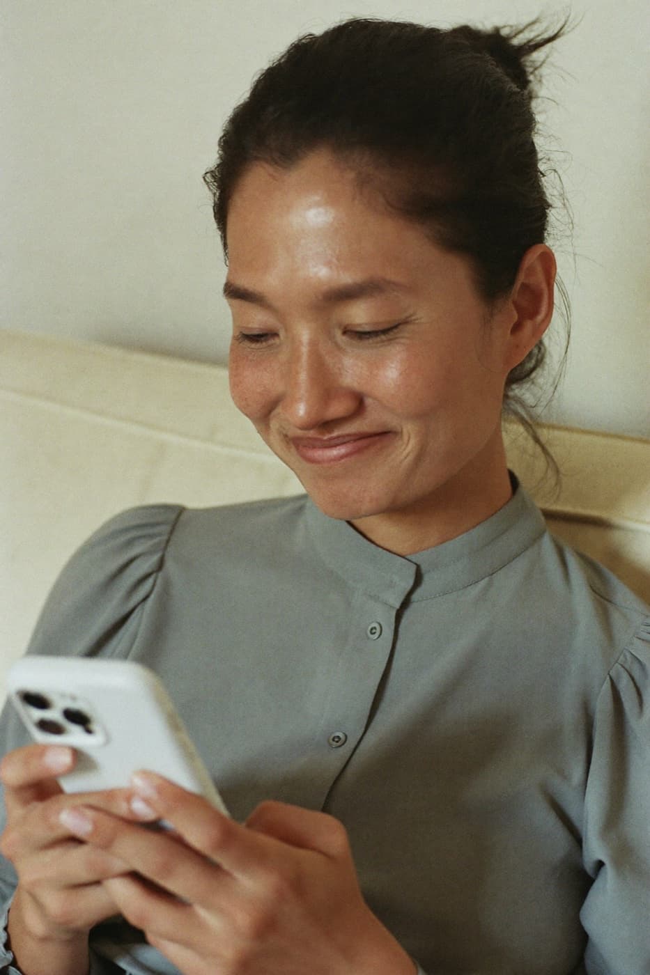 A woman reading her results on her phone
